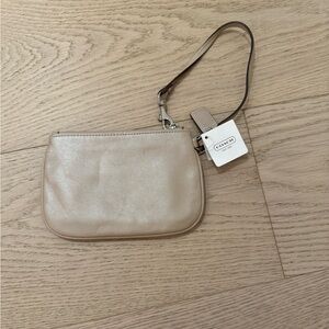 This is a cream/tan Coach wallet with a small wristlet.